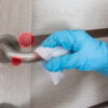Wiping door knob with antibacterial disinfecting wipe for killing coronavirus. Coronavirus COVID-19
